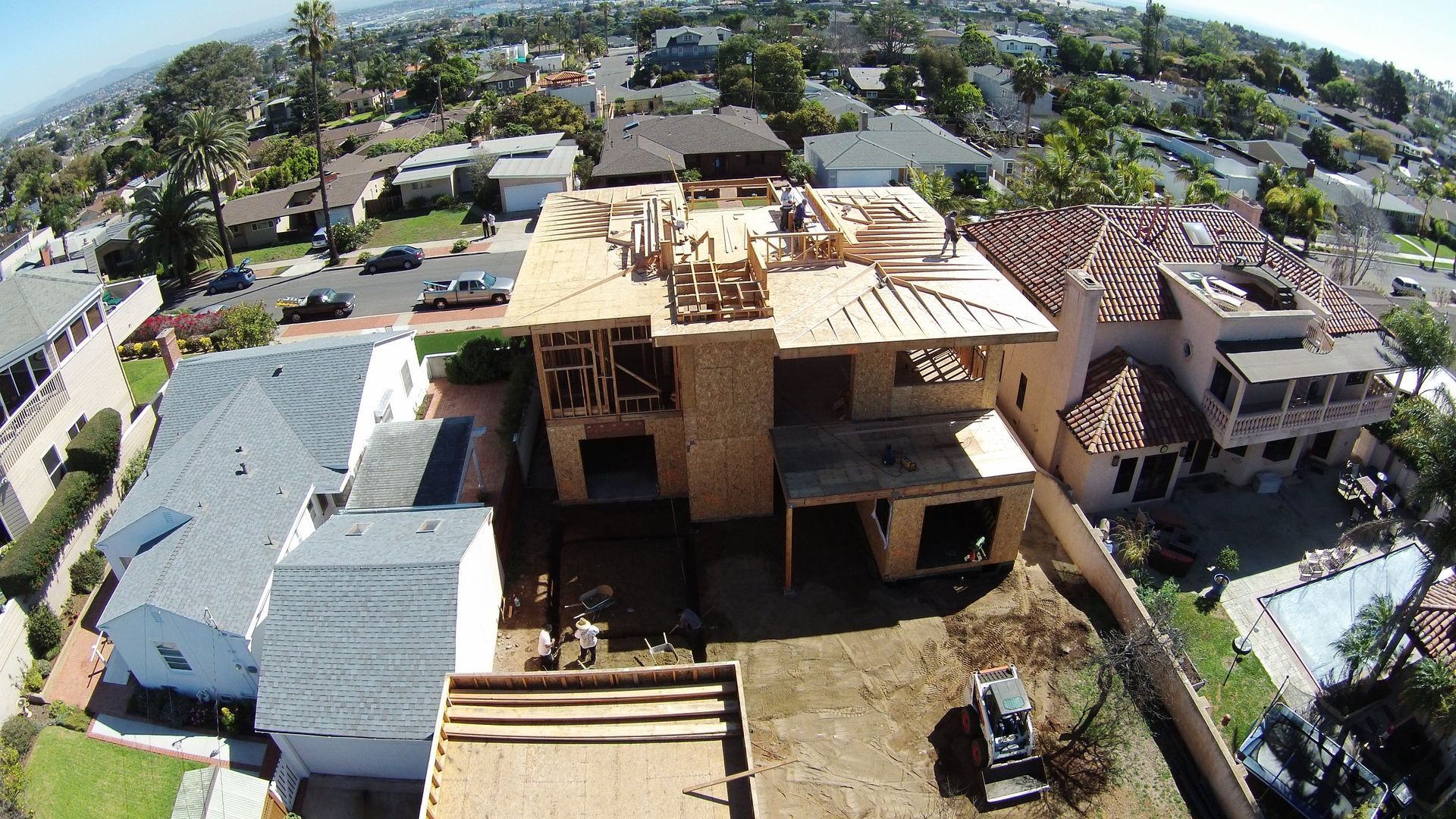 An aerial view of a house under construction in a residential area.