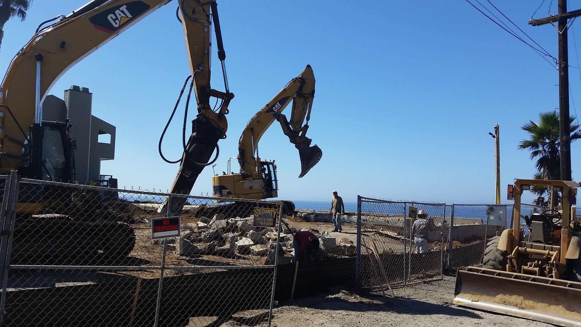A cat excavator is working on a construction site.