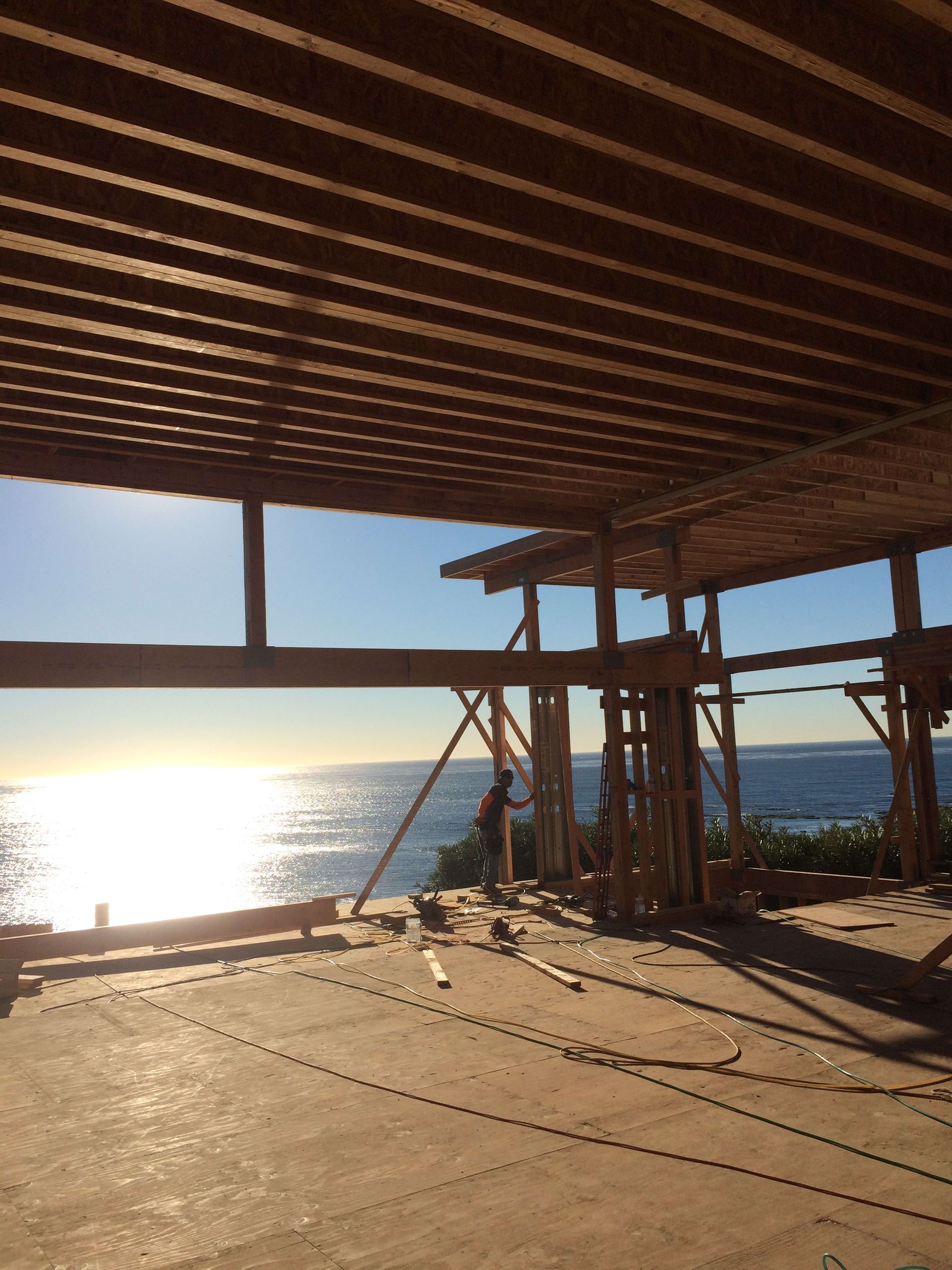 A building under construction with a view of the ocean.