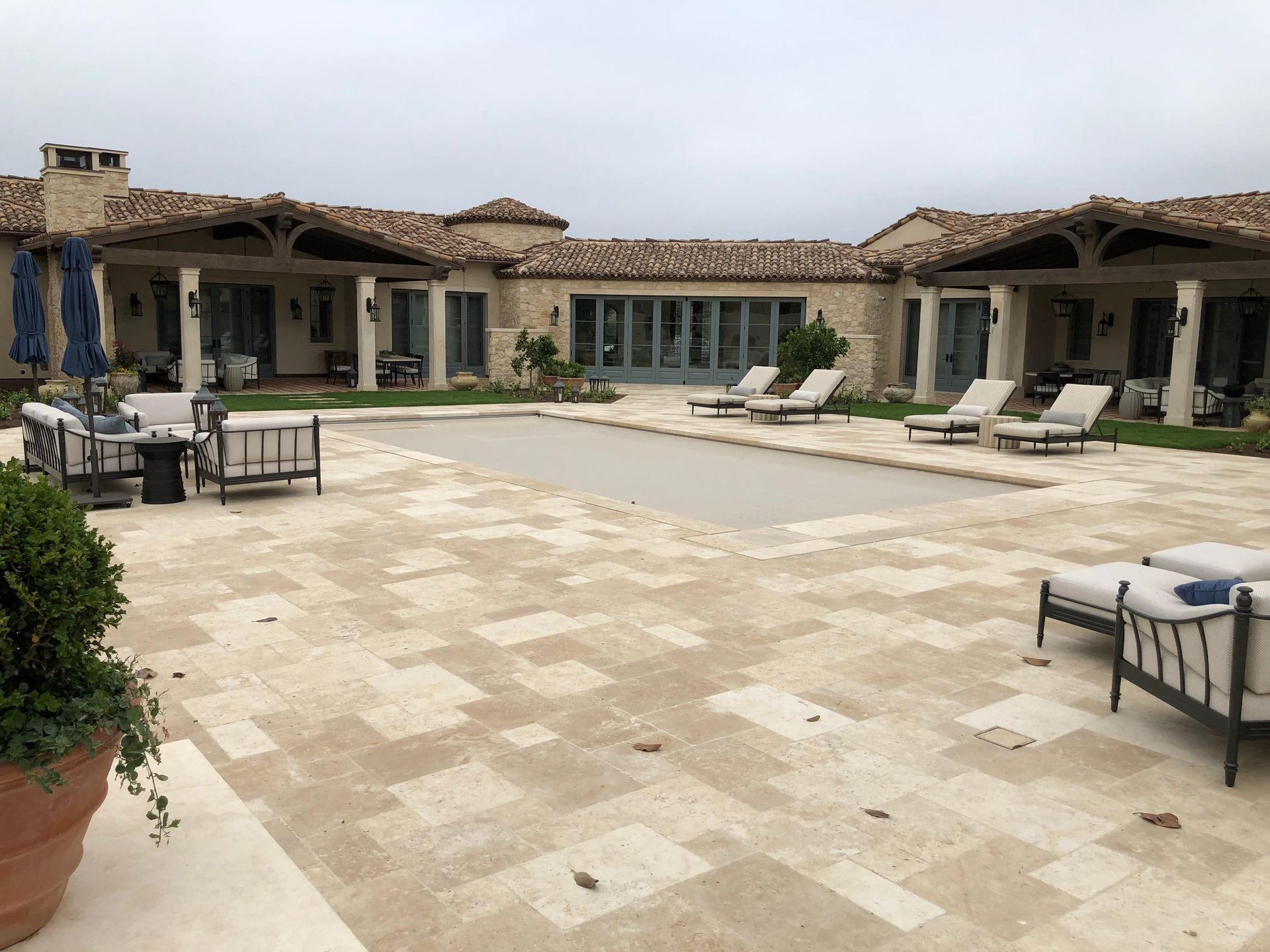 A large house with a large swimming pool in front of it.