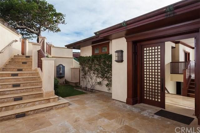 A house with stairs leading up to the front door.