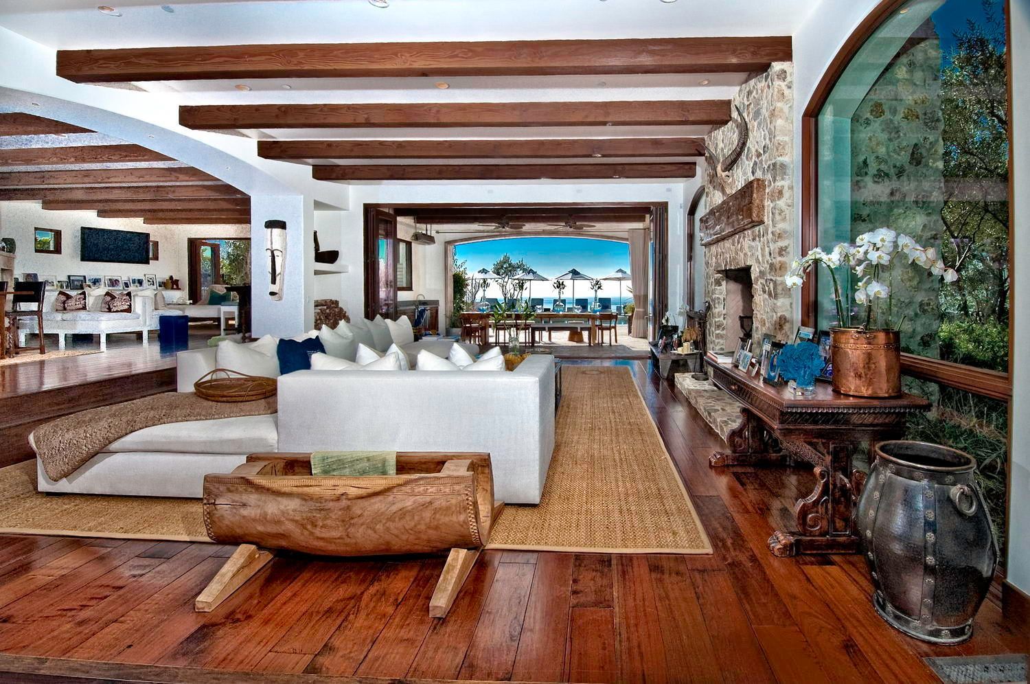A living room with a white couch and a wooden table.