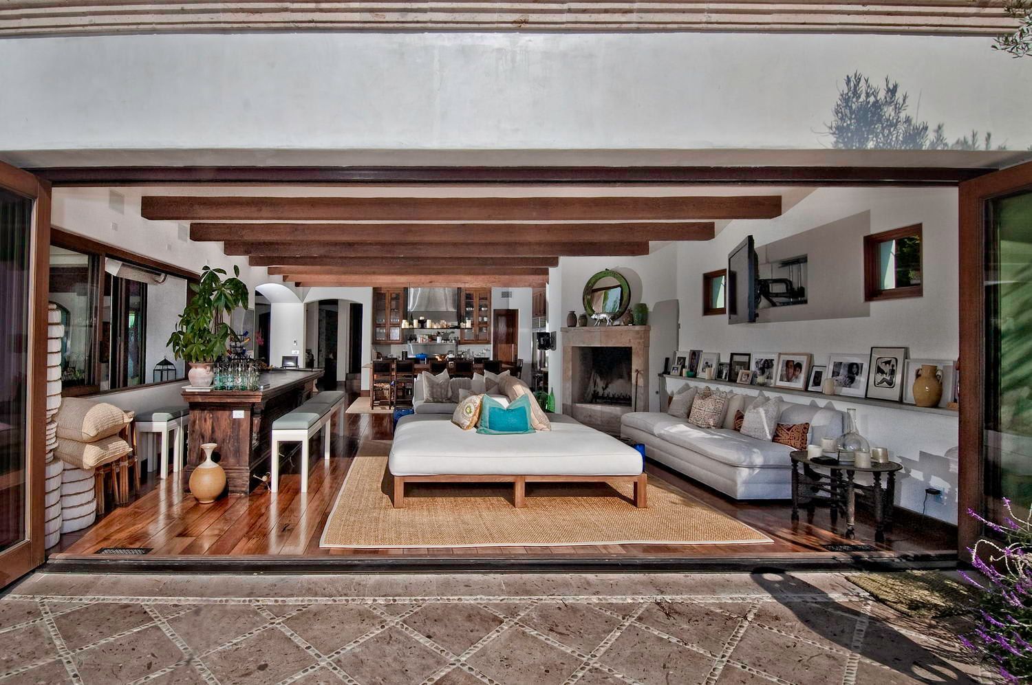 A living room with a large couch and a fireplace.