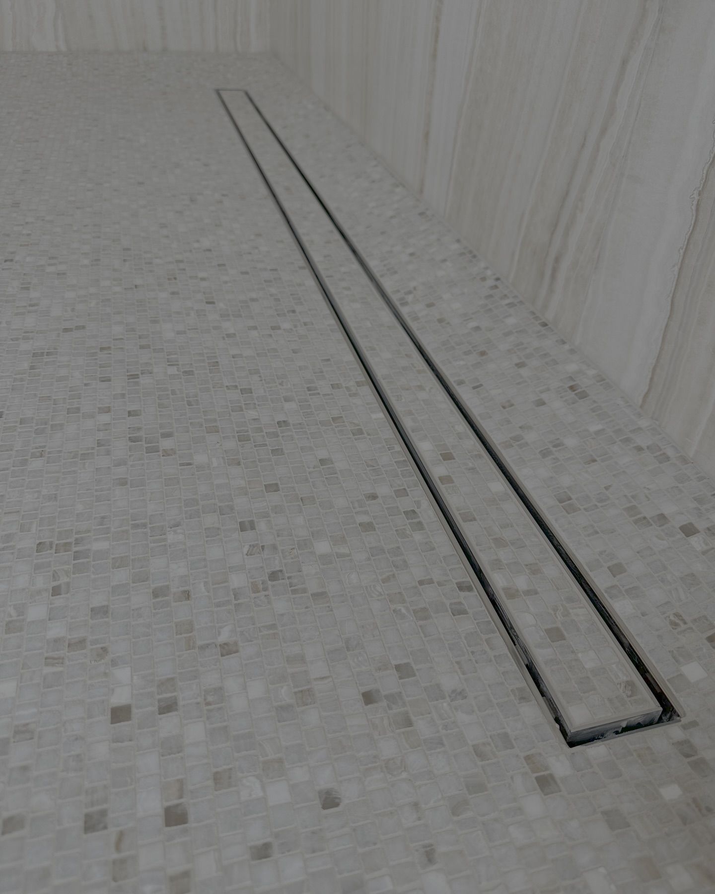 Linear drain in tiled shower floor.