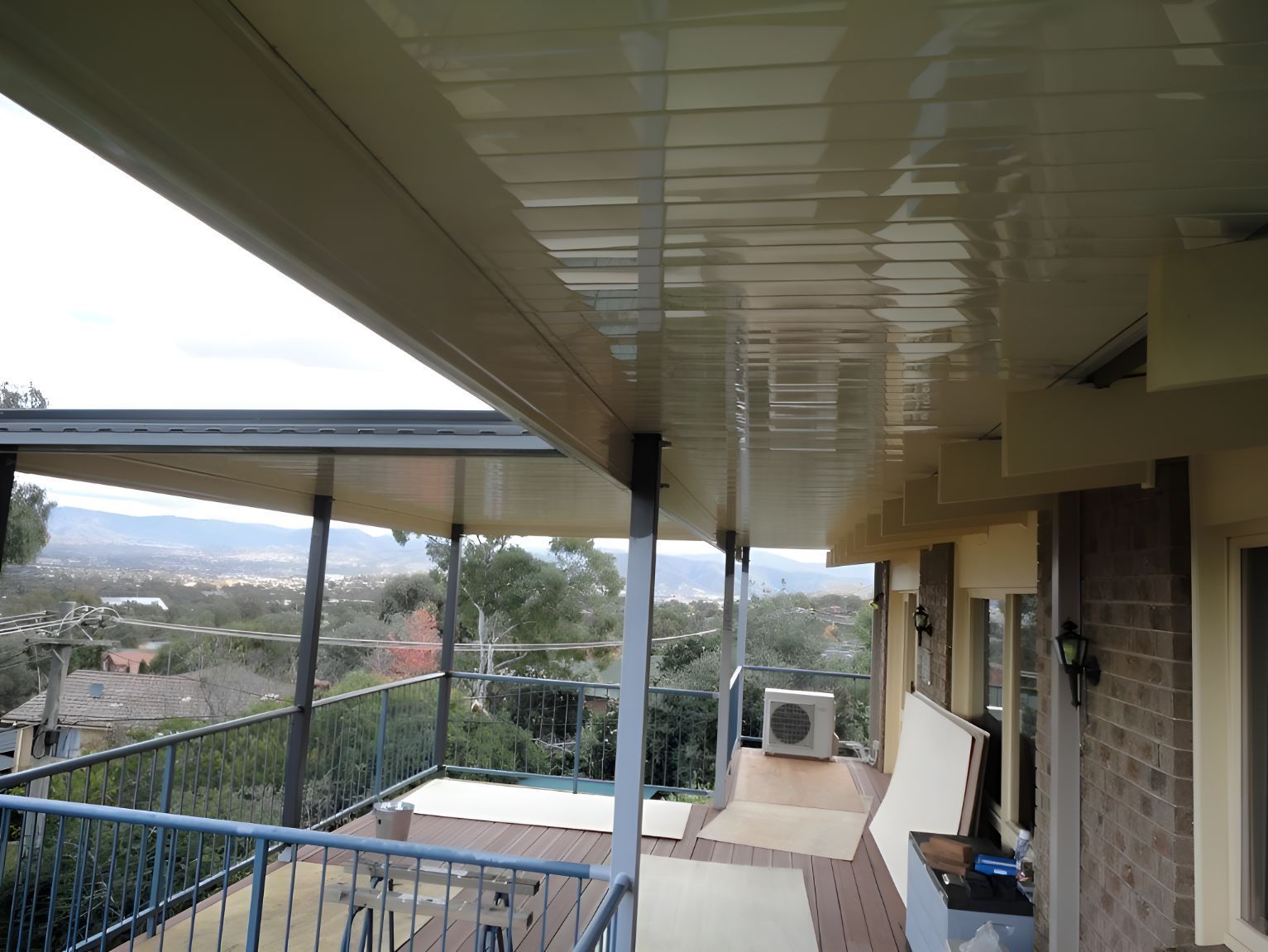 A balcony roof with the view of the city and mountains in the background — All Top Roofing In Royalla, NSW