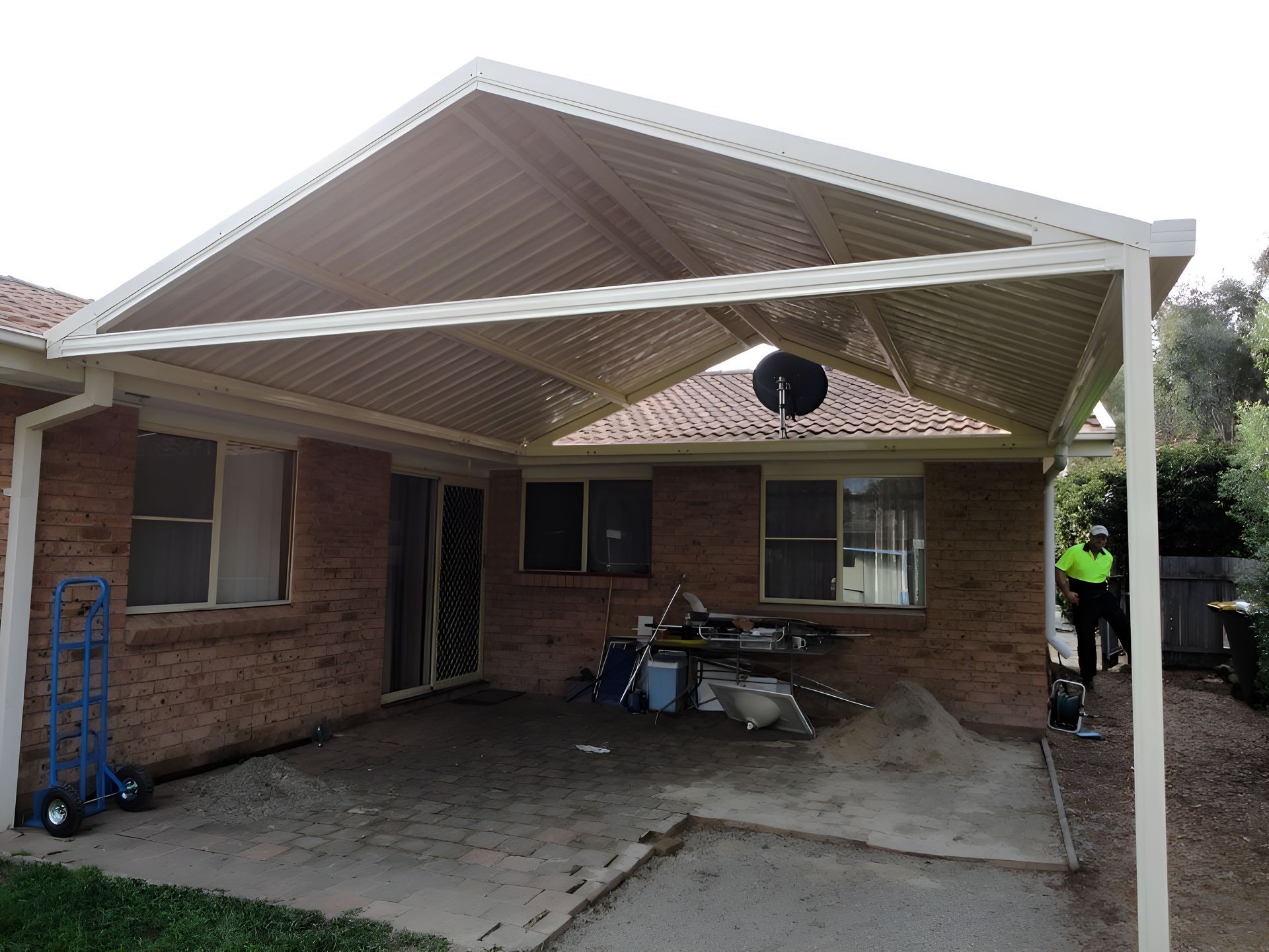 A Brick House With A White Awning Over The Driveway — All Top Roofing In Royalla, NSW