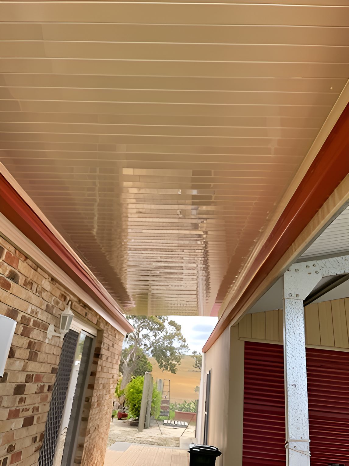 A ceiling of a house with a brick wall and a red door — All Top Roofing In Belconnen, ACT