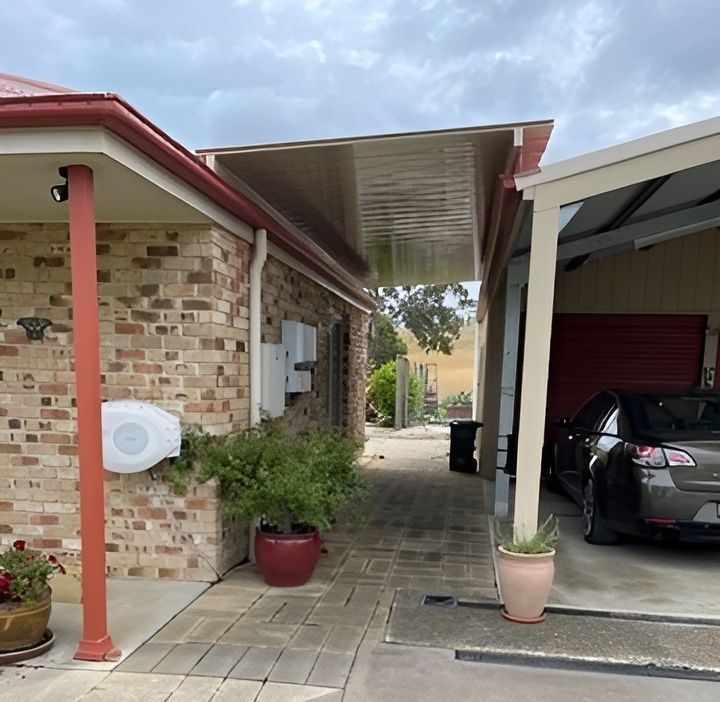 A House With A Balcony And A Satellite Dish On The Roof — All Top Roofing In Royalla, NSW