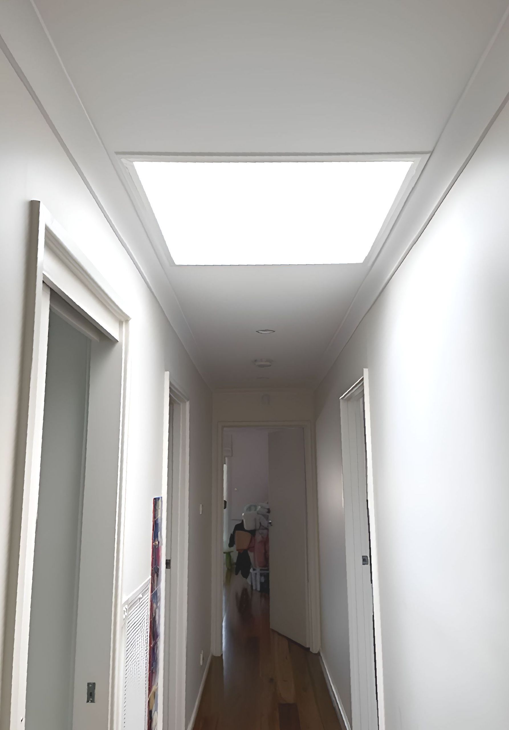 A Long Hallway With A Skylight In The Ceiling — All Top Roofing In Royalla, NSW