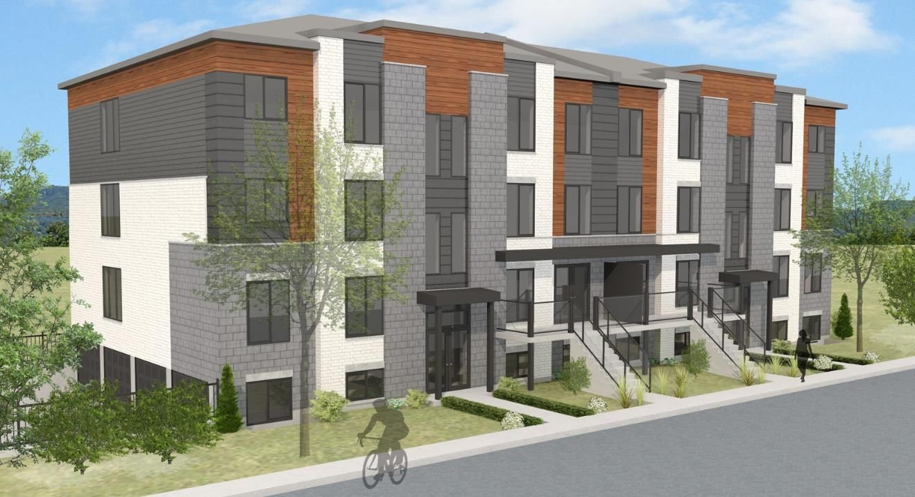 Vue d'artiste d'un bâtiment avec un homme faisant du vélo devant.