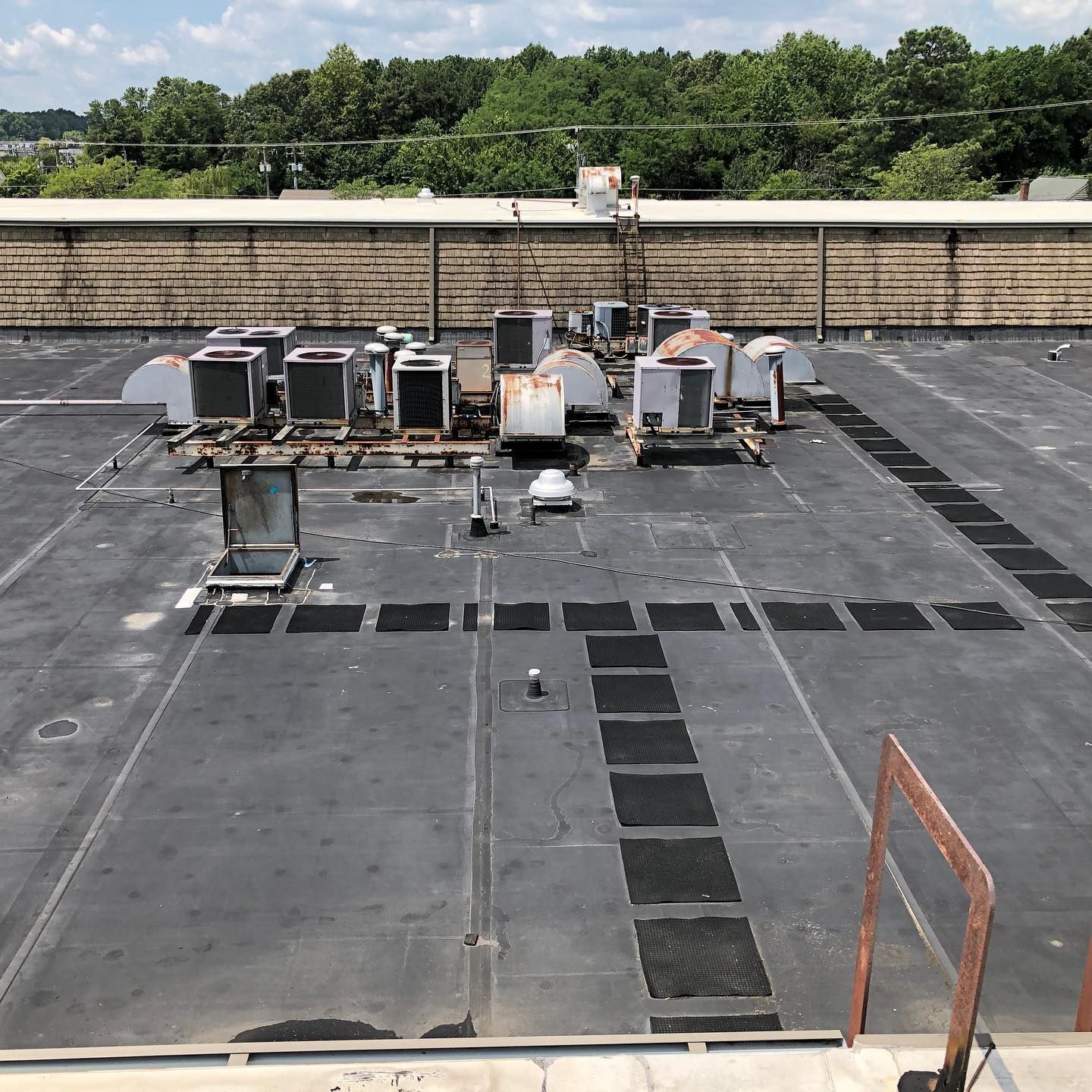 The roof of a building with a lot of air conditioners on it