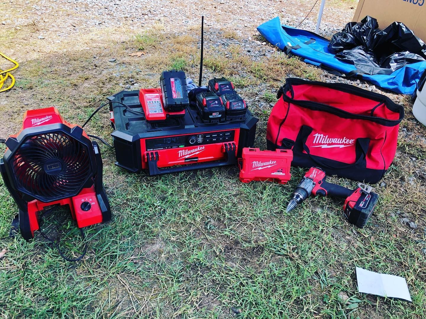 A bunch of tools are sitting on top of a lush green field.