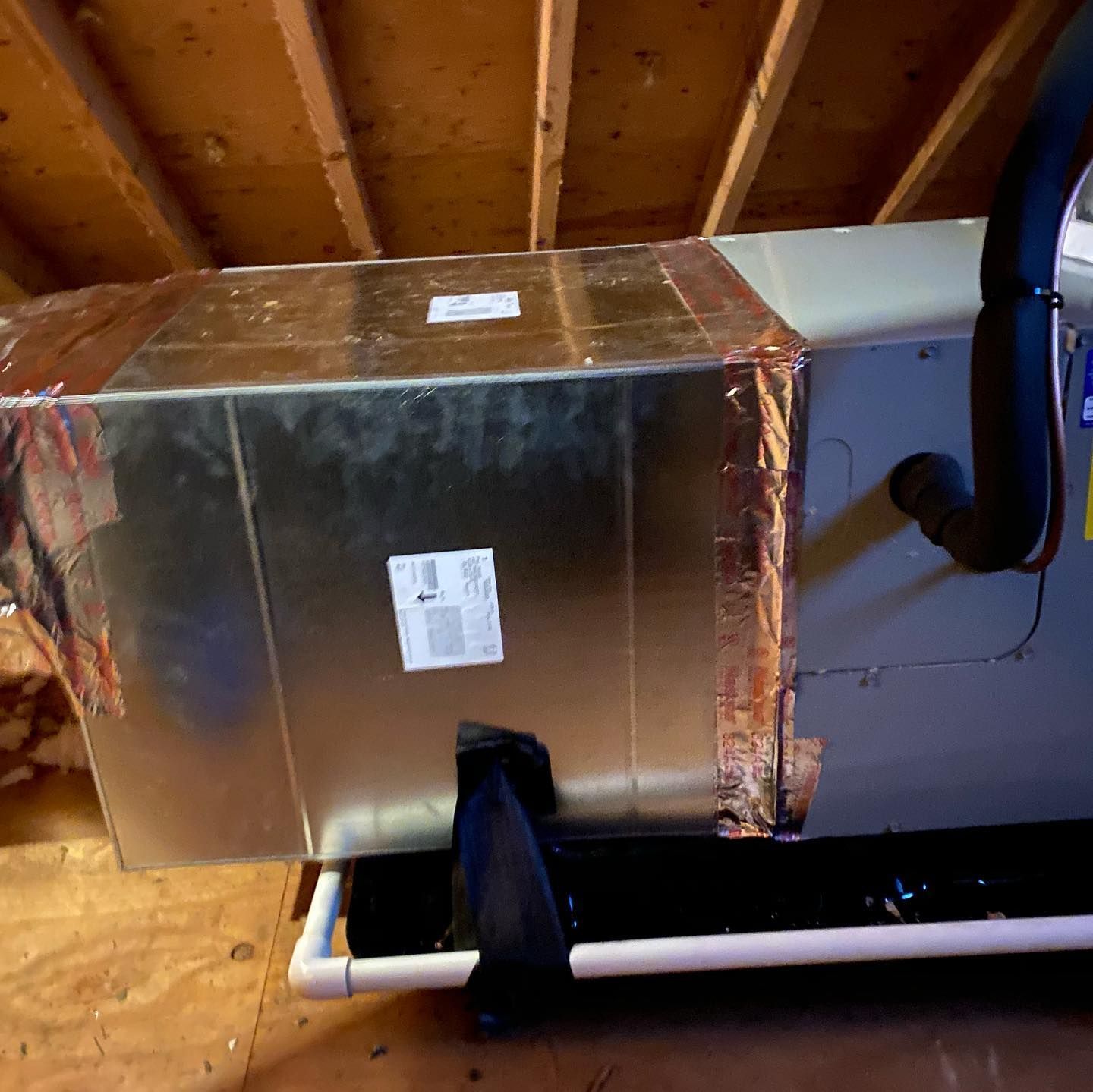 A metal box is sitting on a wooden floor in a room.