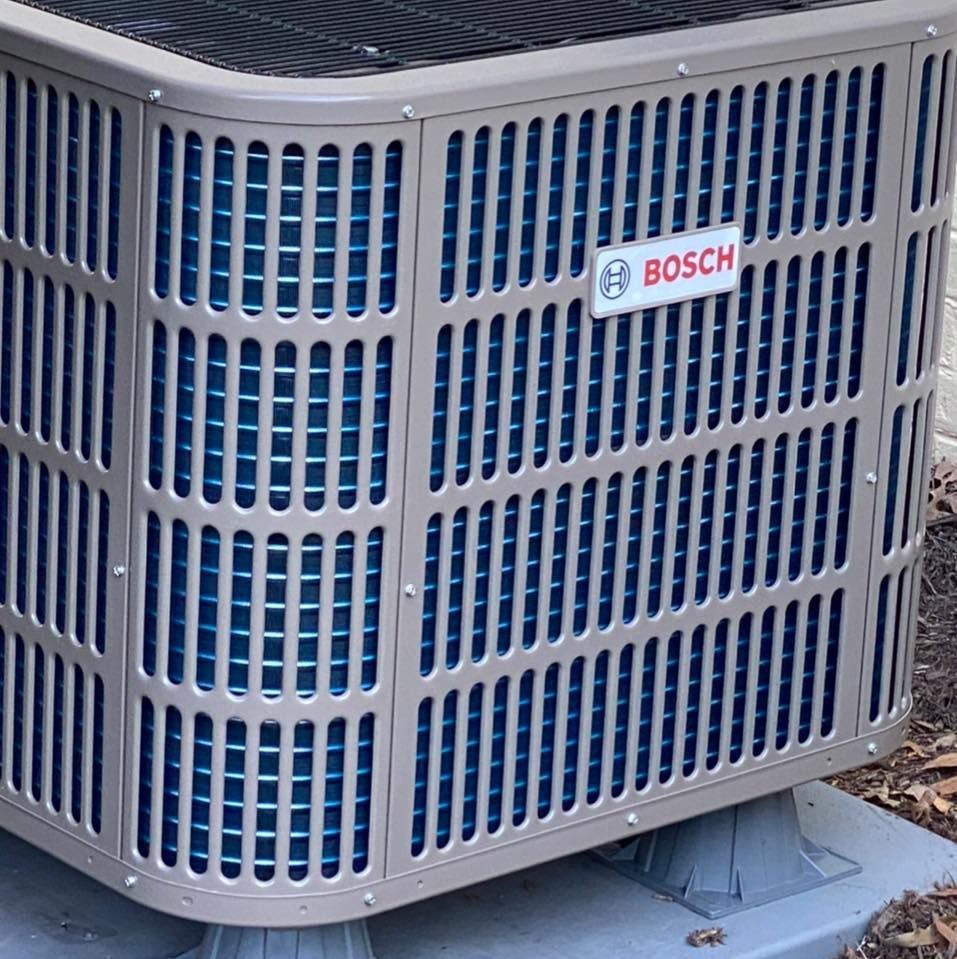 A bosch air conditioner is sitting on a concrete base