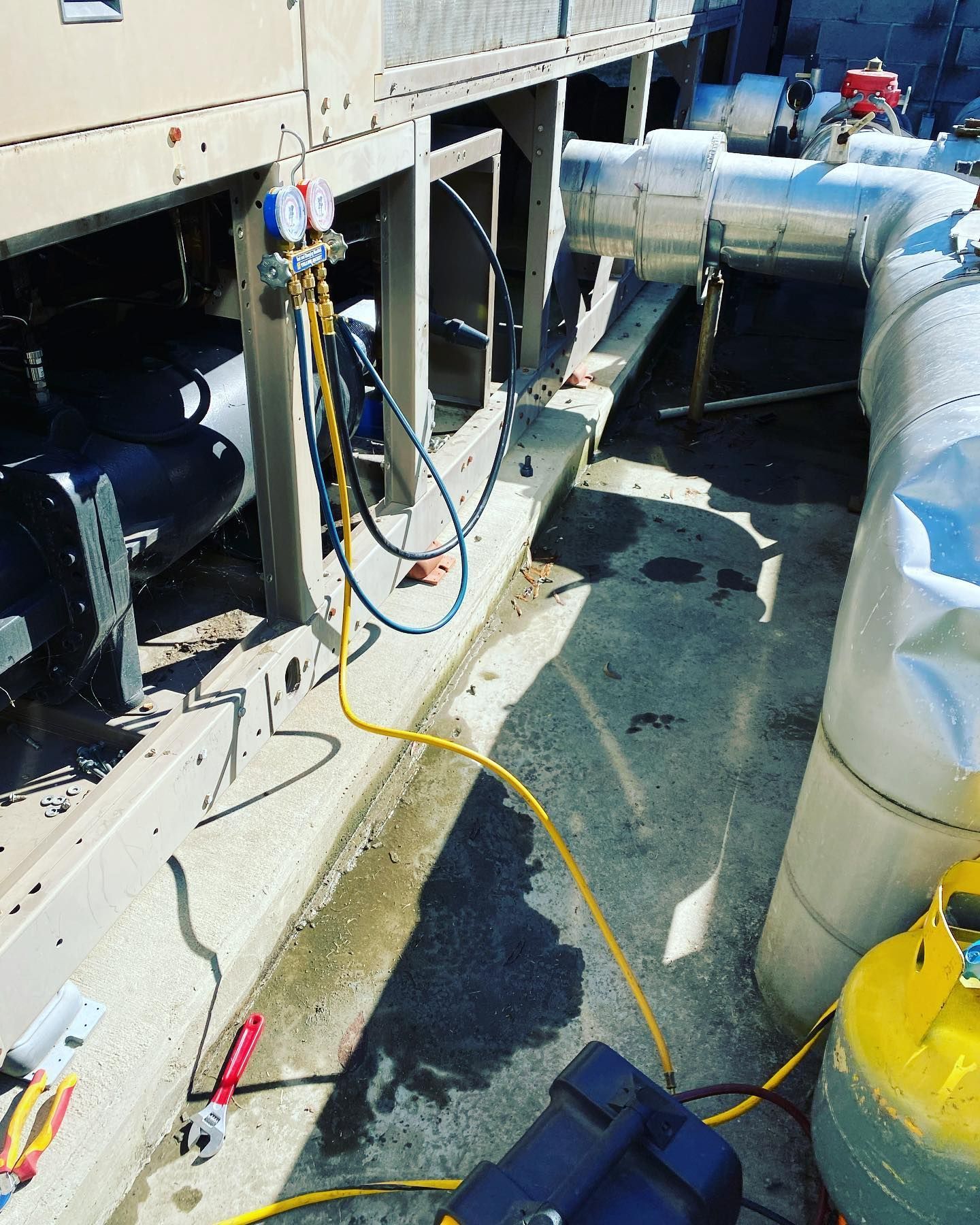 A yellow hose is connected to a machine outside