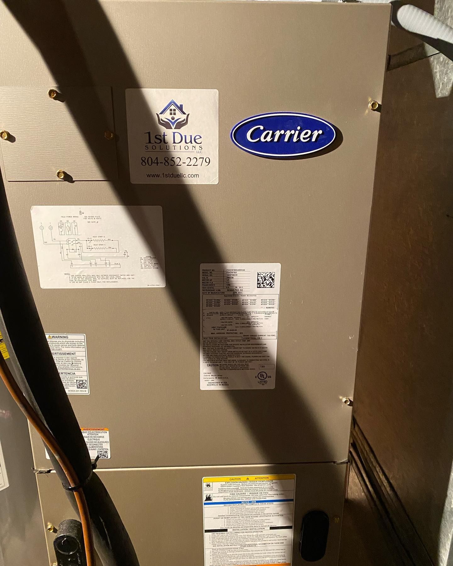 A carrier air conditioner is sitting in a dark room.