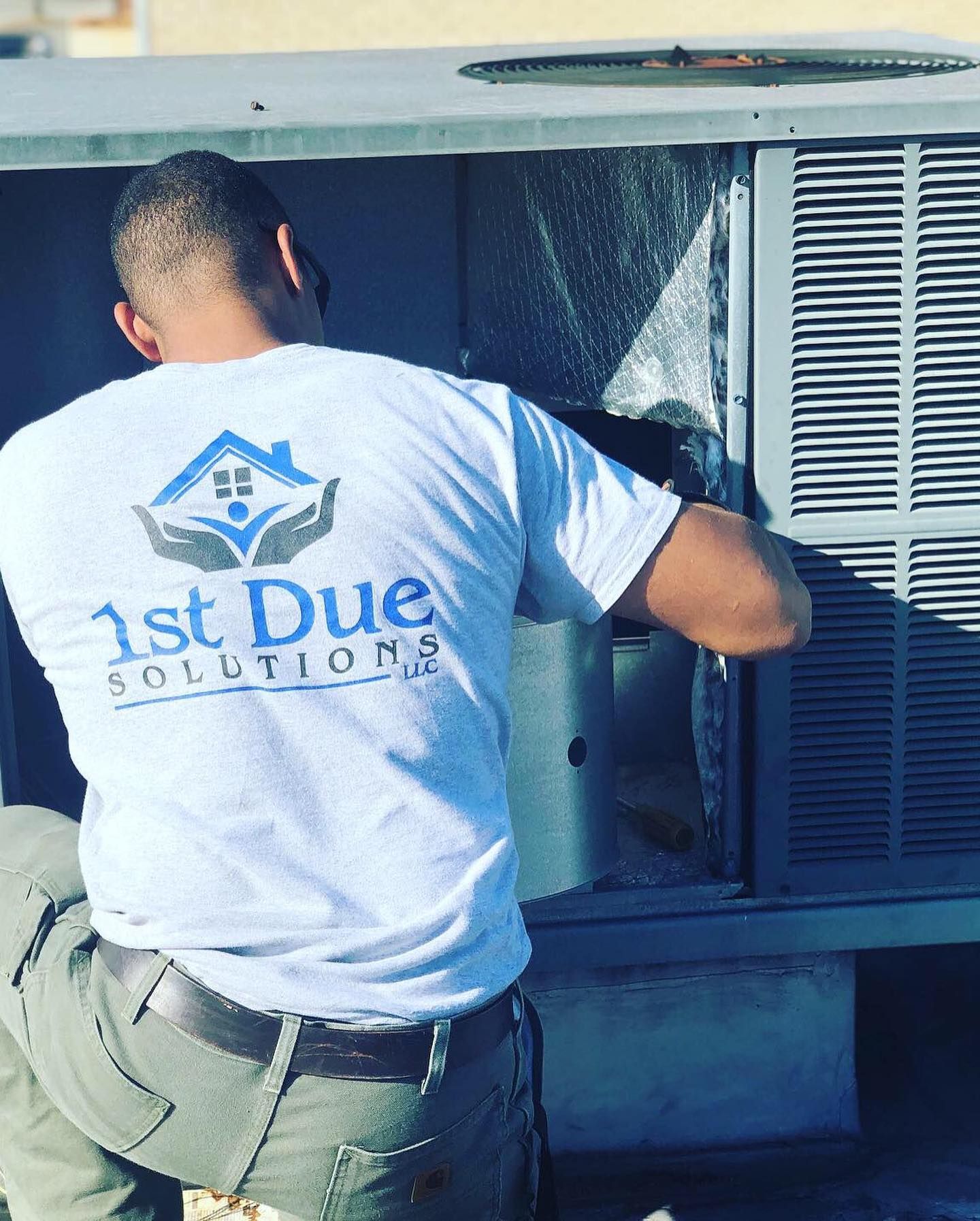 A man wearing a white shirt that says 1st due solutions