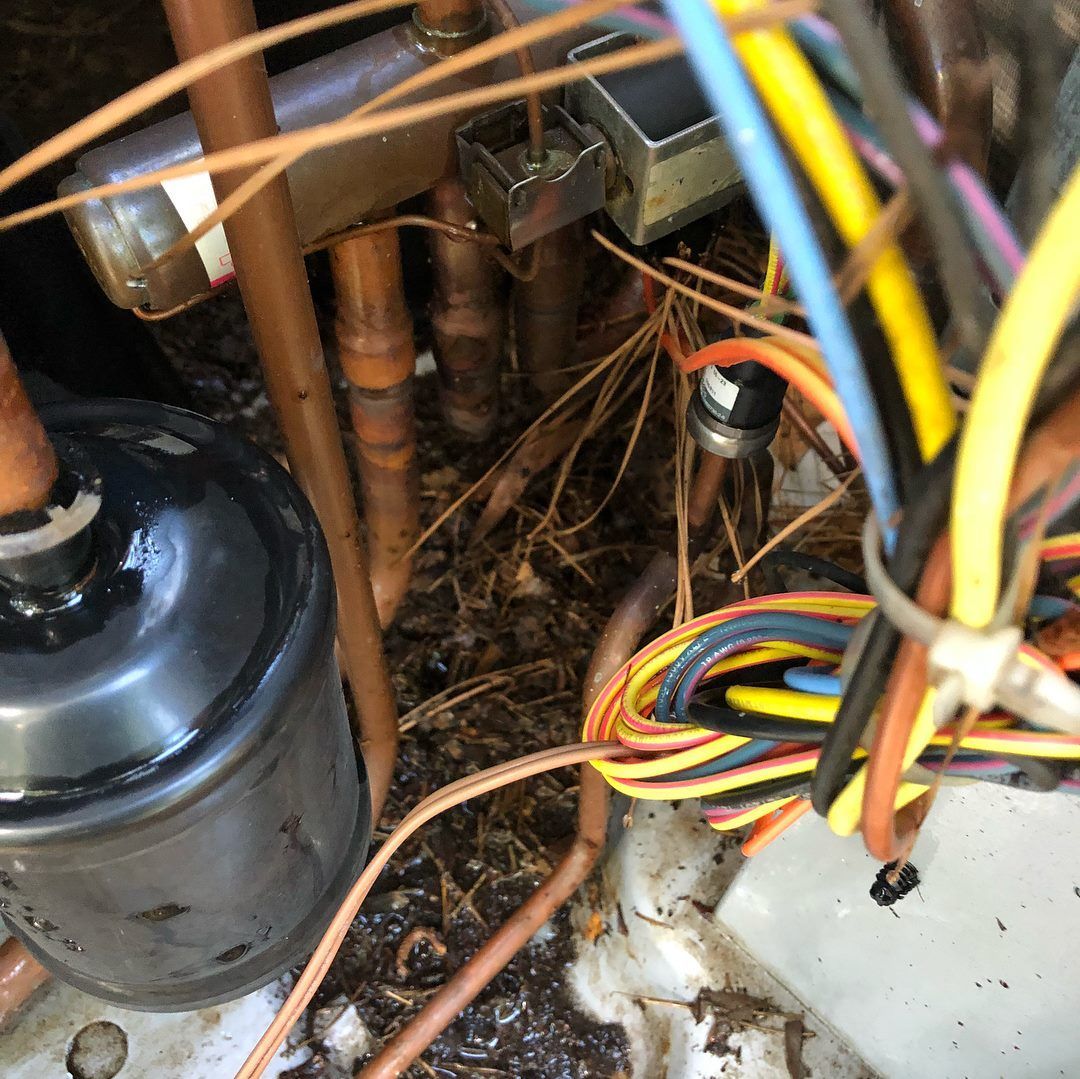 A bunch of wires are connected to a copper pipe