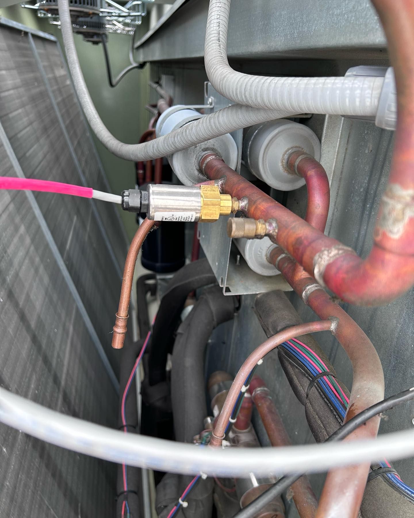 A bunch of pipes and wires are connected to a machine