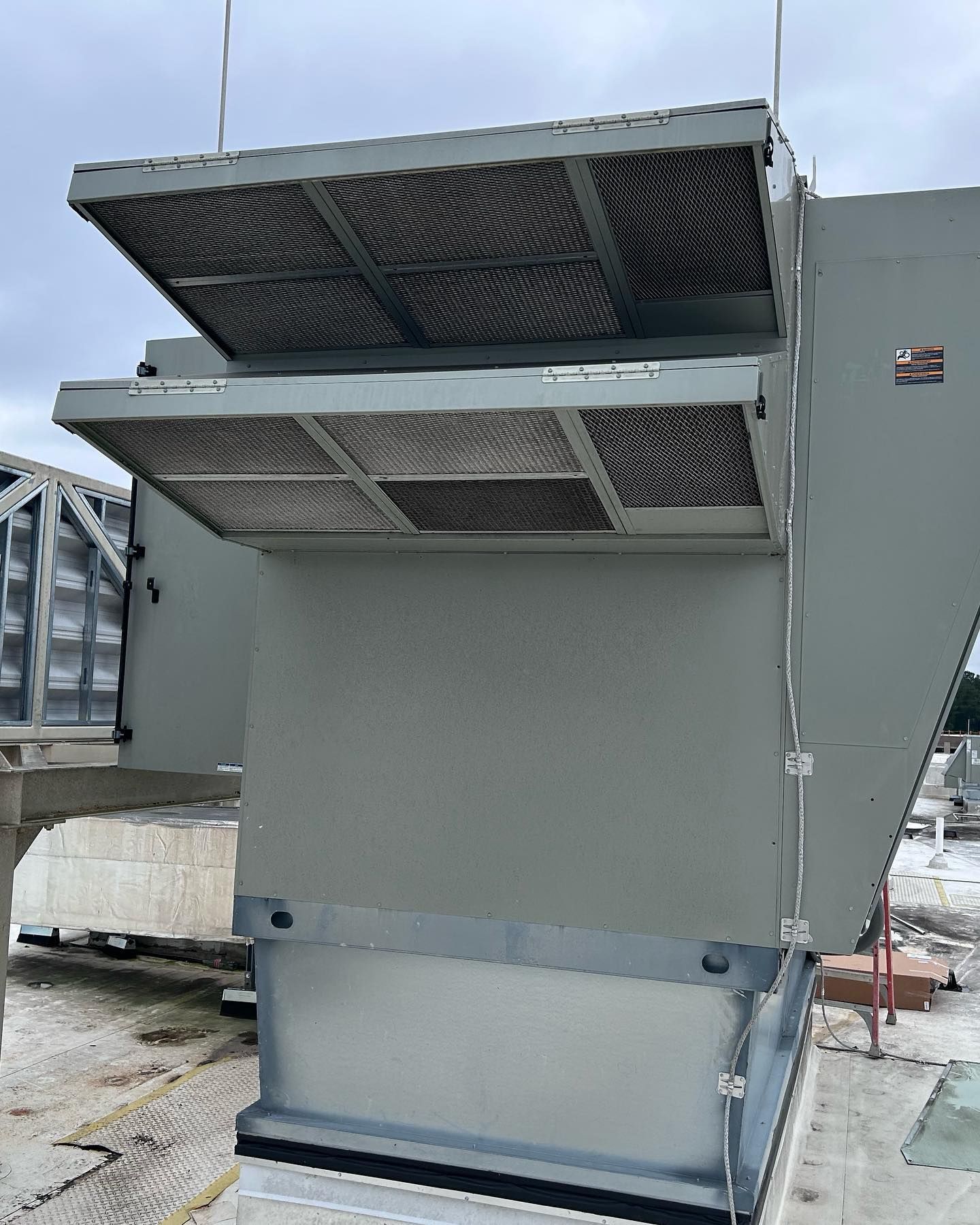 A large gray building with a lot of air coming out of it.