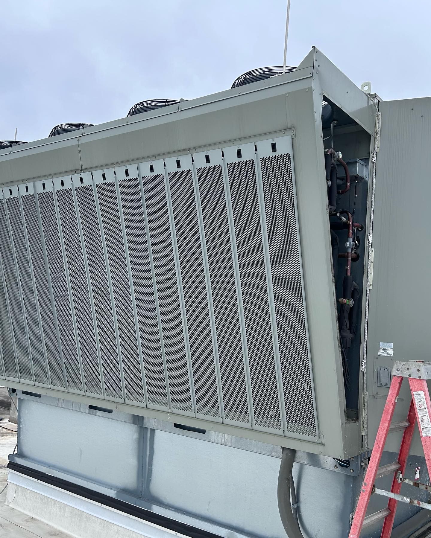 A large gray box with a red ladder next to it.