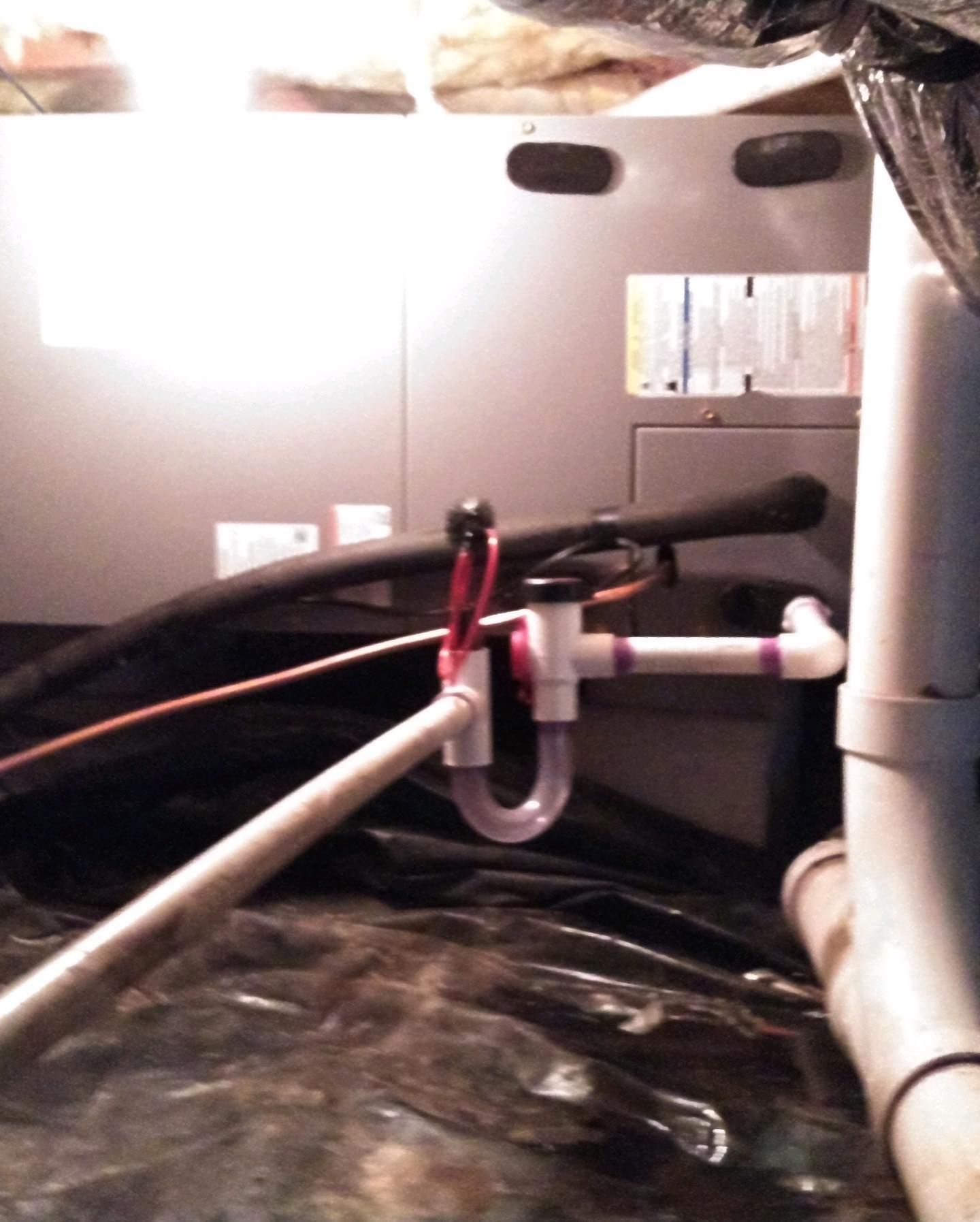 A plumbing pipe is connected to a heater in a basement