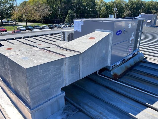 A rooftop with a lot of air conditioners on it