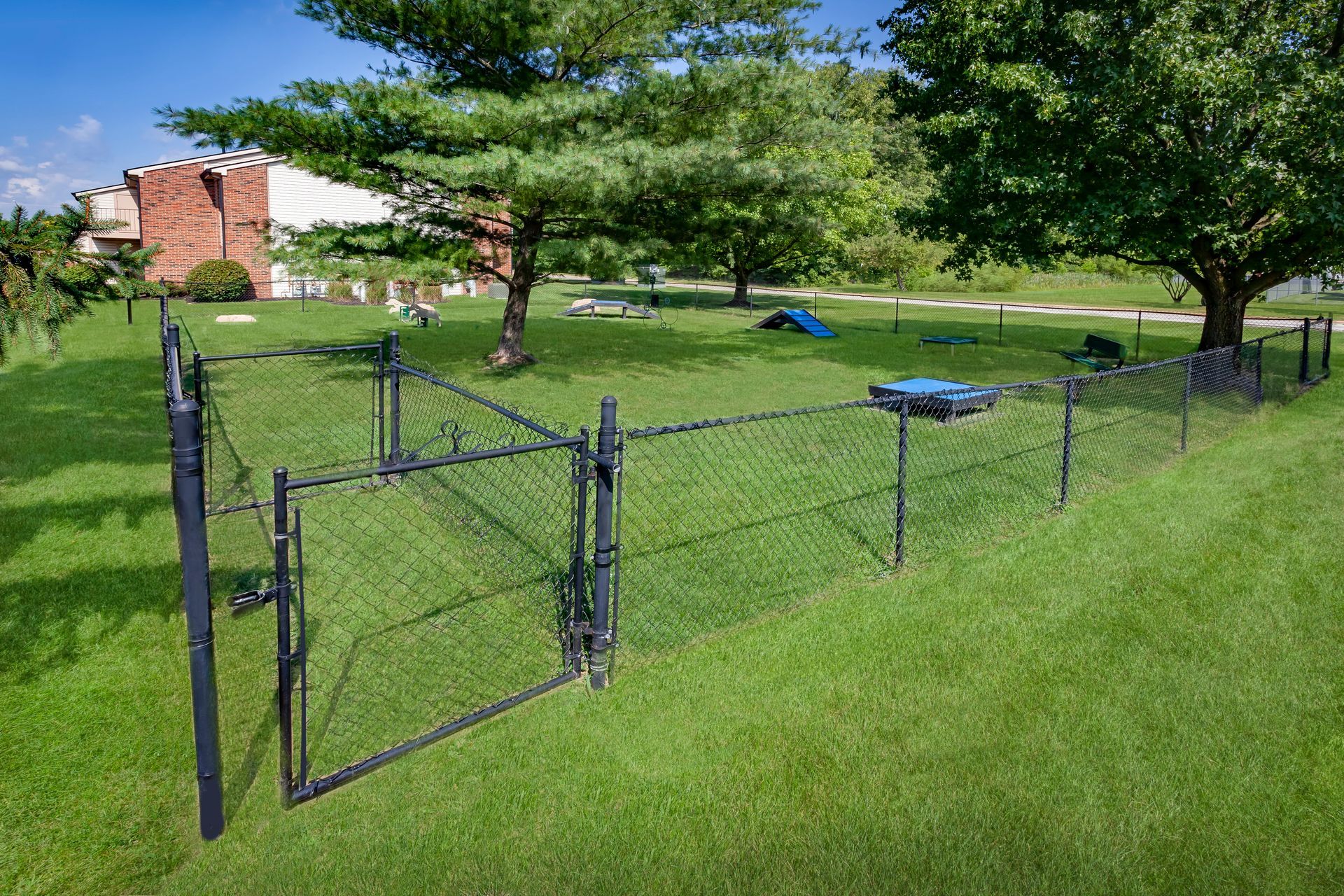 a dog park with a chain link fence and a gate at Greenfield Village.