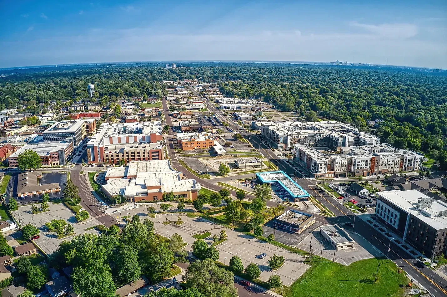 An aerial view of a city surrounded by trees and buildings.