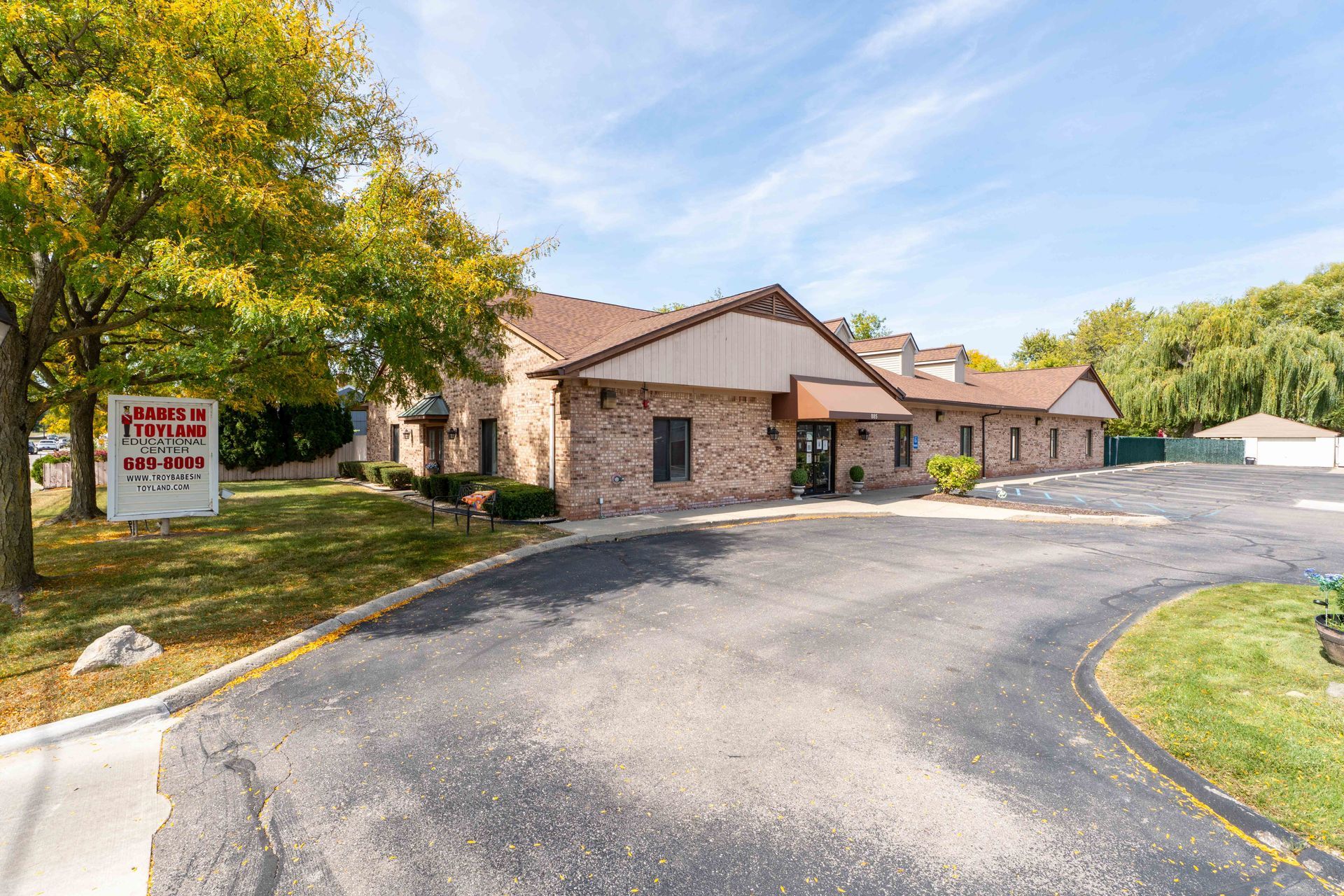 A one-story brick building with a sign that reads 
