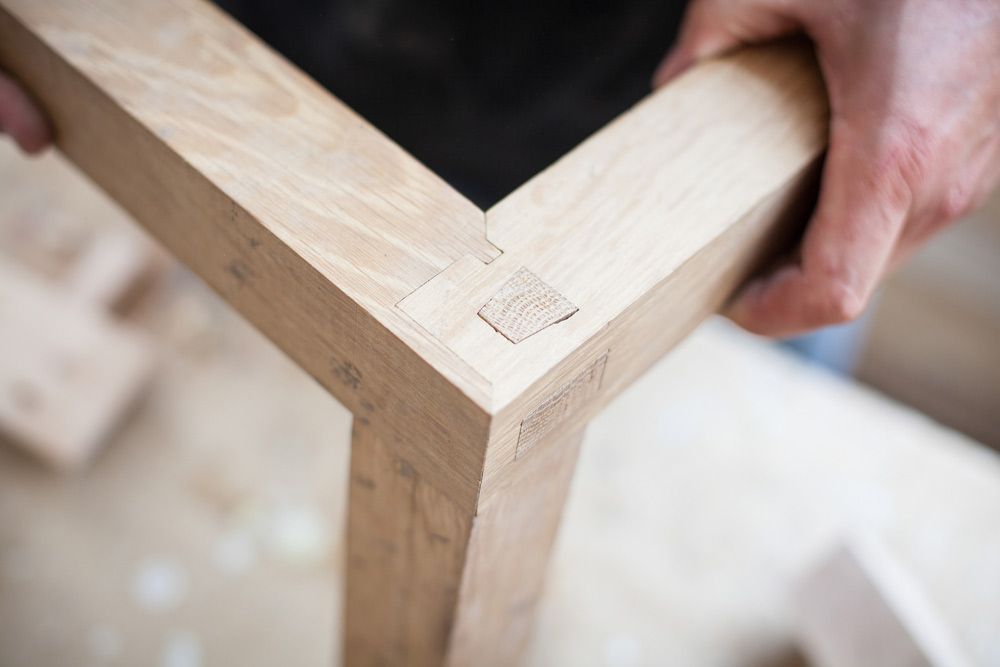 Detail Of A Furniture Maker Holding Wooden Joinery — Prime Edge Joinery Pty Ltd in Flinders, NSW