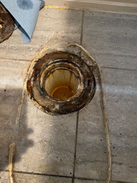 There is a hole in the floor that looks like a bucket