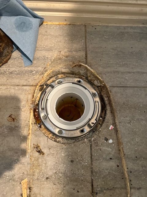 There is a hole in the floor that looks like a toilet flange