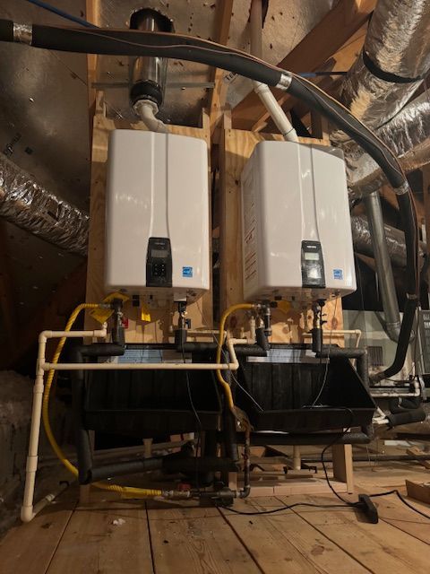 Two water heaters are connected to each other in an attic