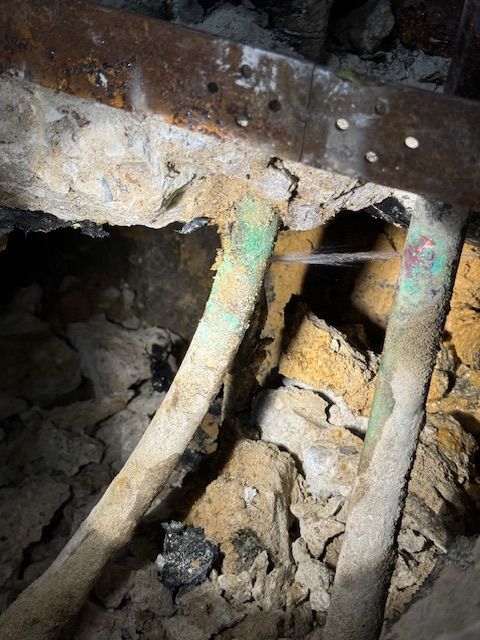 A close up of a pipe in a hole in the ground