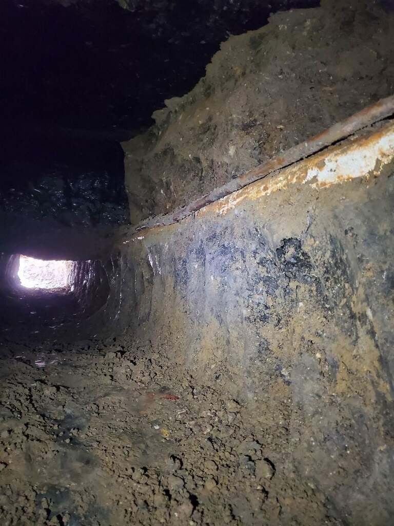 A large pile of dirt is sitting in a dark room