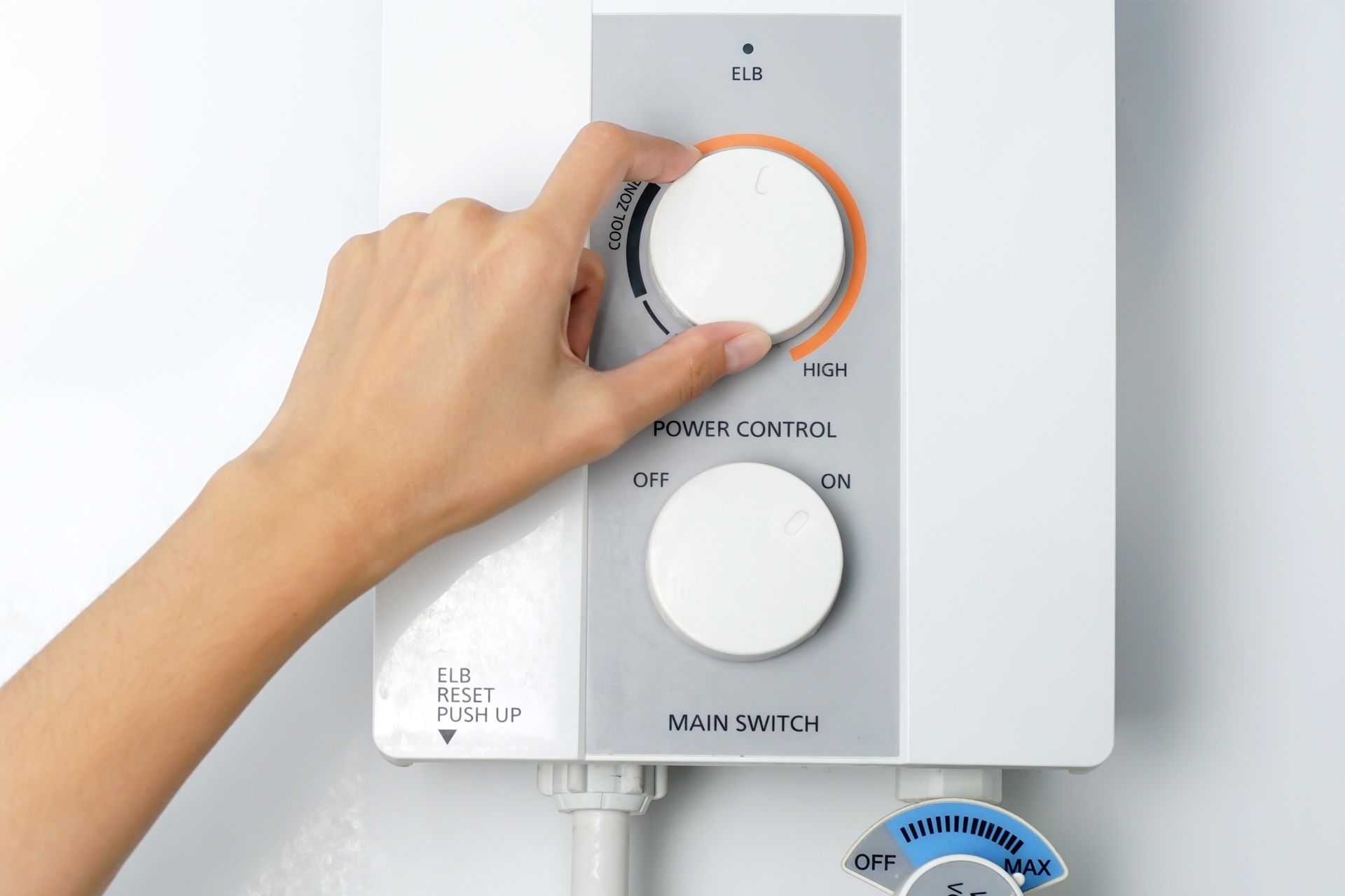 A person is adjusting the temperature of a water heater