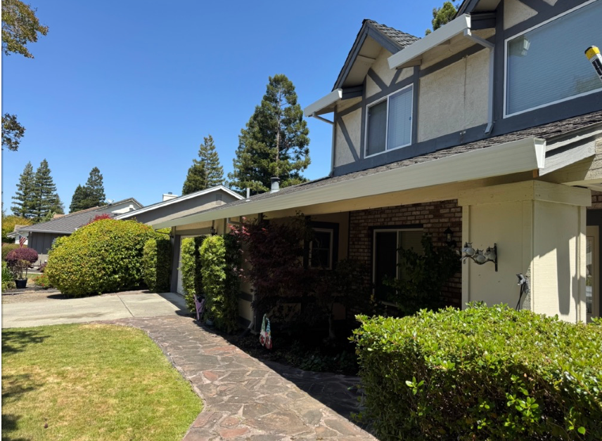 linen gutters with dark downspout