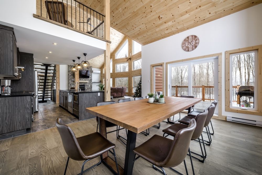 A large dining room with a wooden table and chairs.