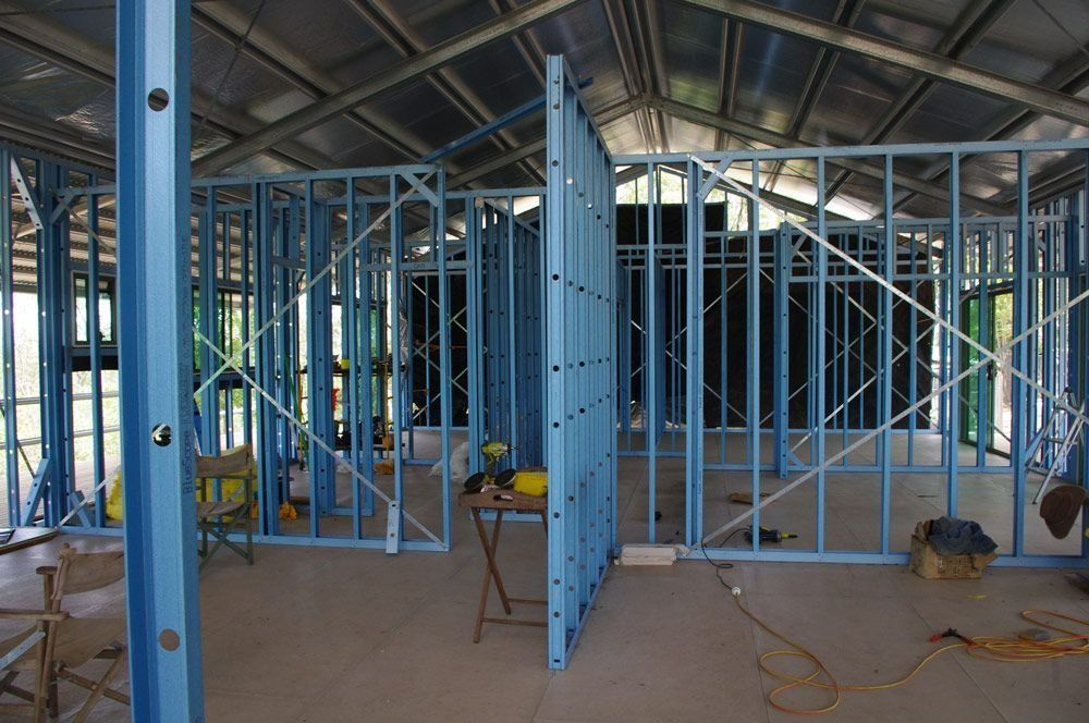 The Inside of A Building Under Construction with Blue Steel Frames — All Steel Homes in Branyan, QLD