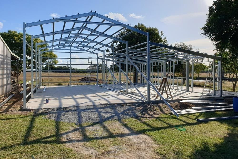 A Large Metal Structure Is Being Built in A Field — All Steel Homes in Childers, QLD