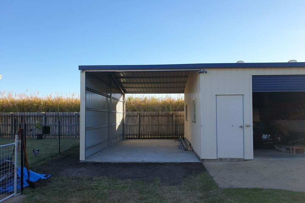 A Garage with A Canopy Over It and A Fence in The Background — All Steel Homes in Bundaberg, QLD