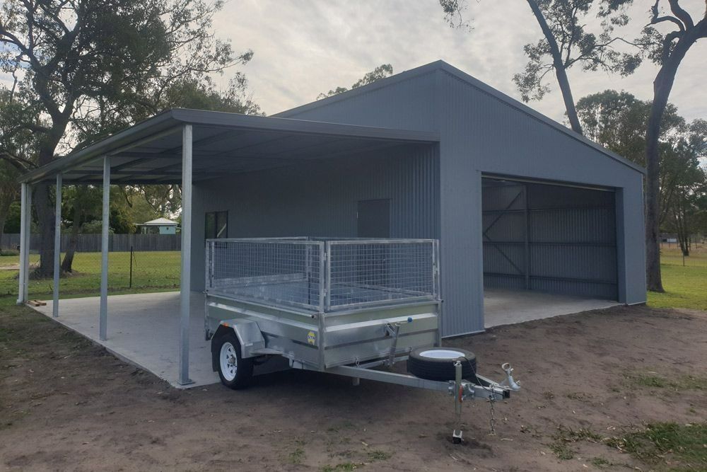 A Trailer Is Parked in Front of A Garage with A Canopy — All Steel Homes in Branyan, QLD