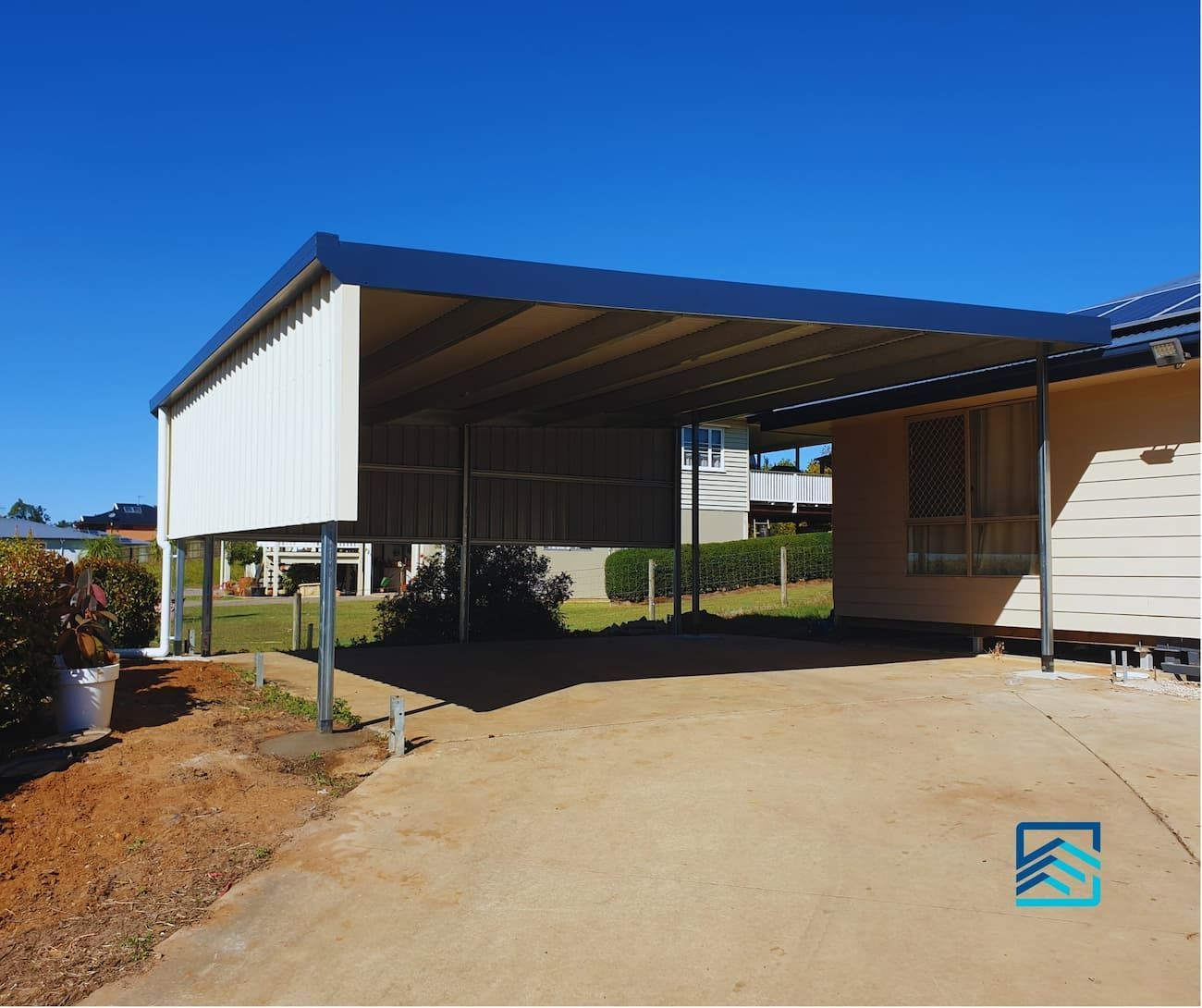 A Carport in Front of A House with A Blue Sky in The Background — All Steel Homes in Branyan, QLD