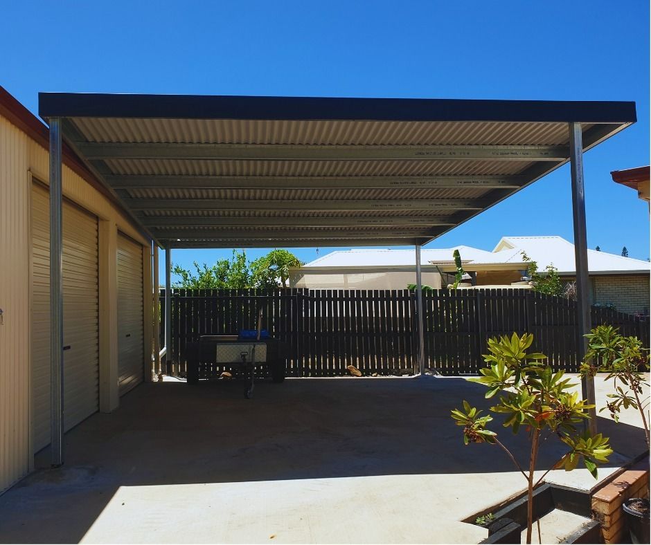 A Carport with A Fence in The Background — All Steel Homes in Branyan, QLD