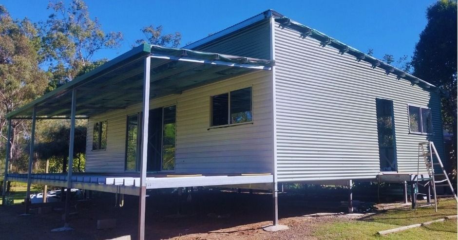 A White House with A Porch and A Blue Sky in The Background — All Steel Homes in Branyan, QLD