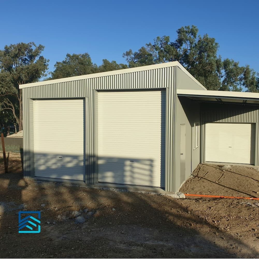 A Gray Garage with White Garage Doors and A Blue Logo — All Steel Homes in Branyan, QLD
