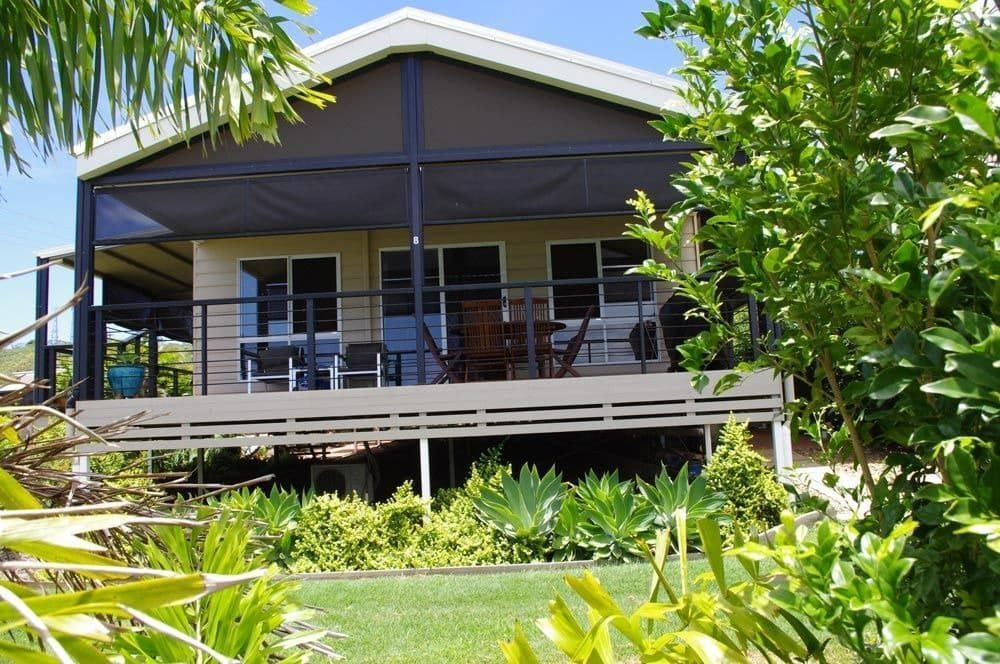 A House with A Screened in Porch Surrounded by Trees — All Steel Homes in Maryborough, QLD