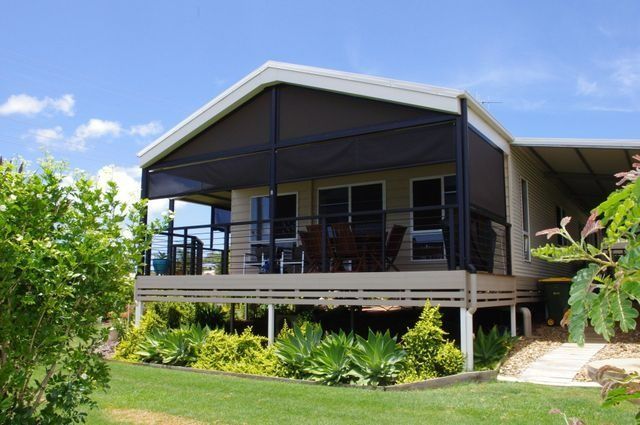 A House with A Screened in Porch and A Lawn in Front of It — All Steel Homes in Branyan, QLD