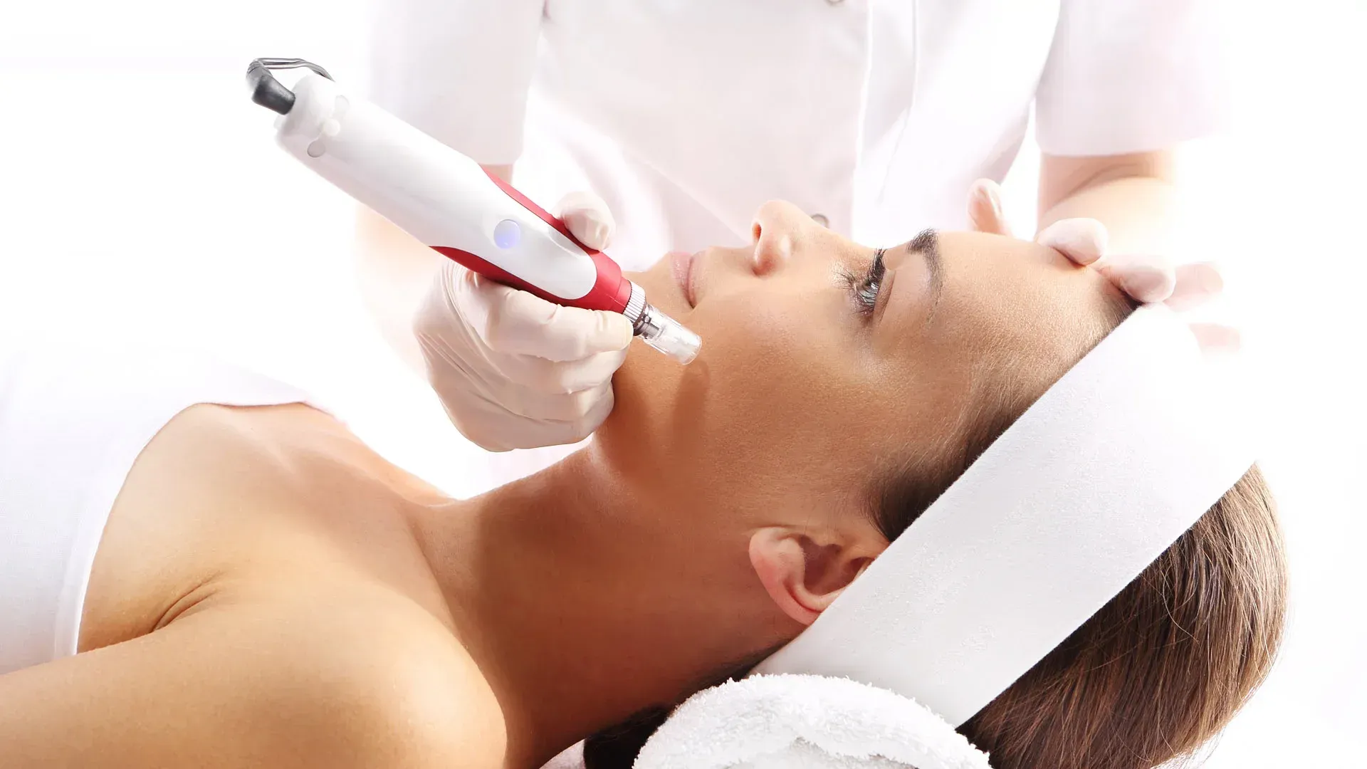 A woman is getting a facial treatment at a beauty salon.